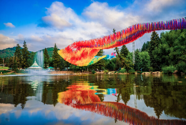 Off the Beaten Path art installation Green Mountain Falls reflecting in Gazebo Lake against mountain backdrop